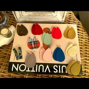 TWELVE pairs of leather earrings